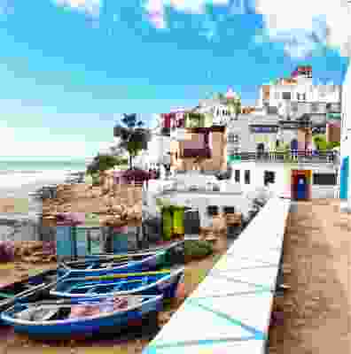 Boats lined along the shore of Taghazout beach, Morocco.