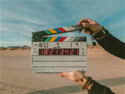 Hands holding a clapperboard