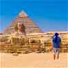 Male traveller looking over Egypt Pyramids and Sphinx in Middle East